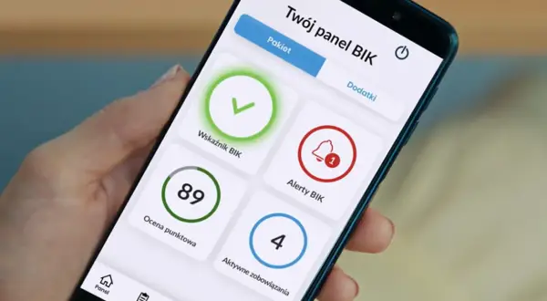 Na ekranie telefonu widać panel BIK z alertami. Widoczny jest wskaźnik BIK, ocena punktowa 89, alerty BIK z powiadomieniem oraz aktywne zobowiązania.